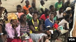 New refugee arrivals from South Sudan wait to register at the Imvempi reception center in Arua district, Uganda, Jan. 30, 2018. (H. Athumani/VOA)