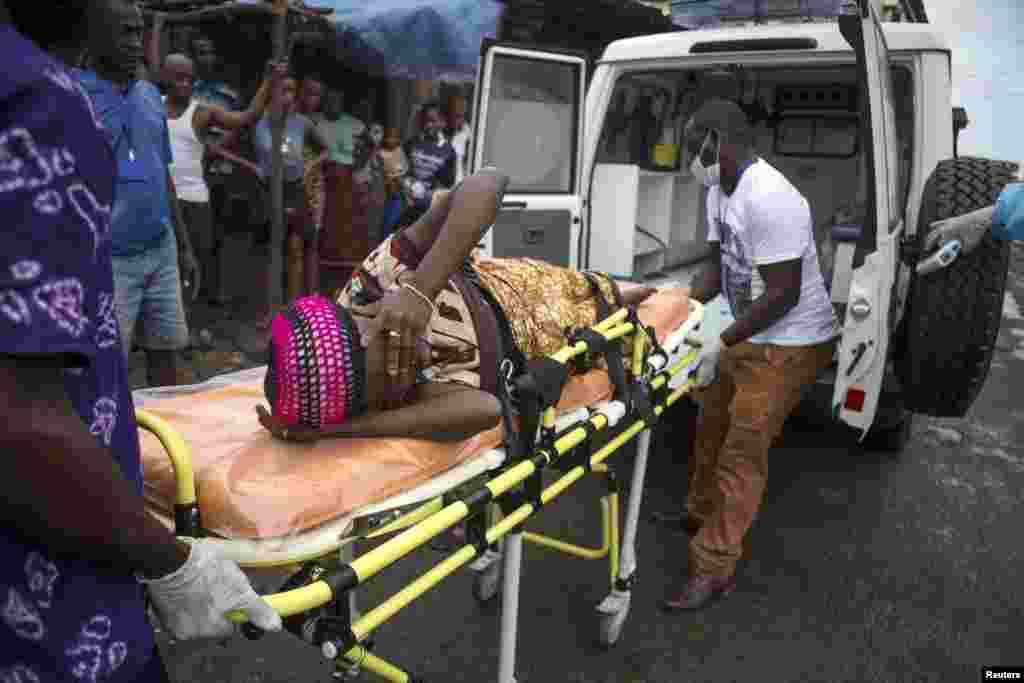 A pregnant woman suspected of contracting Ebola is lifted by stretcher into an ambulance in Freetown, Sierra Leone Sept. 19, 2014 in a handout photo provided by UNICEF.