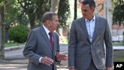 In a photo provided by the Spanish government, exiled Venezuelan opposition leader Edmundo Gonzalez, left, walks with Spain's Prime Minister Pedro Sanchez outside Moncloa Palace in Madrid, Sept. 12, 2024. (Fernando Calvo, Spanish Government via AP)