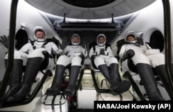 Roscosmos cosmonaut Alexander Grebenkin, left, and from second left to right, NASA astronauts Michael Barratt, Matthew Dominick and Jeanette Epps in the SpaceX Dragon Endeavour spacecraft after landing in the Gulf of Mexico, Oct. 25, 2024. (NASA/Joel Kowsky via AP)