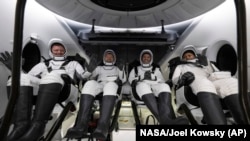 FILE - Roscosmos cosmonaut Alexander Grebenkin, left, and NASA astronauts, left to right, Michael Barratt, Matthew Dominick and Jeanette Epps in the SpaceX Dragon Endeavour spacecraft after landing in the Gulf of Mexico, Oct. 25, 2024. (NASA/Joel Kowsky via AP)