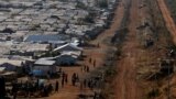 FILE - Internally displaced people gather by a water collection point in a United Nations Mission in South Sudan (UNMISS) Protection of Civilian site (PoC), outside the capital Juba, South Sudan, Jan. 25, 2017.