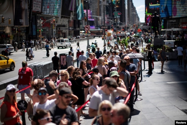 FILE - People wait in line to buy entertainment tickets for shows at Times Square after the Centers for Disease Control and Prevention dropped some of its restrictive COVID-19 preventative measures, including social distancing, in New York, U.S., August 12, 2022. (REUTERS/Eduardo Munoz)