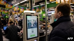 Perwakilan grup X5 mendemonstrasikan sistem pembayaran dengan teknologi pengenalan wajah di mesin kasir mandiri di supermarket Perekrestok, Moskow, Rusia, 9 Maret 2021. (Foto: Dimitar DILKOFF / AFP)