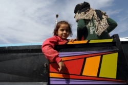 A girl is seen at a back of a truck in the border town of Tel Abyad, Syria, Oct. 14, 2019.