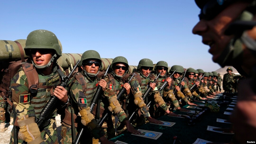 FILE - Afghan soldiers take their oaths before a training exercise at the Kabul Military Training Center, Oct. 22, 2014. 