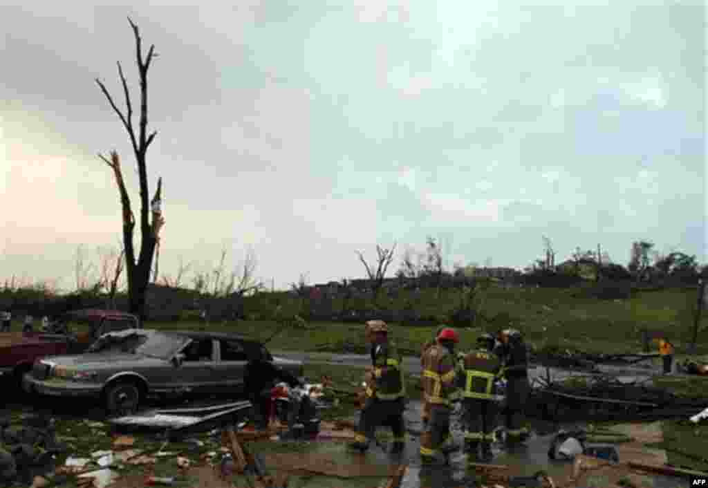 Birmingham Rescue attends to a man who was injured after a tornado hits Pratt City just north of downtown Birmingham on Wednesday, April 27, 2011, in Birmingham, Ala. (AP Photo/Butch Dill)