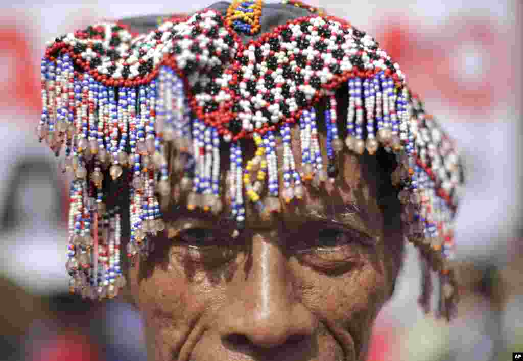 A Philippine indigenous person known as "Lumad" from southern Philippines wears their traditional headwear as he joins a rally near the Malacanang palace in Manila.