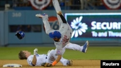 FILE - New York Mets shortstop Ruben Tejada suffered a broken leg on this play when Los Angeles Dodgers second baseman Chase Utley rolled toward him to try to break up a double play in a National League playoff game at Dodger Stadium, Oct 10, 2015.