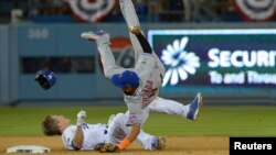 FILE - New York Mets shortstop Ruben Tejada suffered a broken leg on this play when Los Angeles Dodgers second baseman Chase Utley rolled toward him to try to break up a double play in a National League playoff game at Dodger Stadium, Oct 10, 2015.