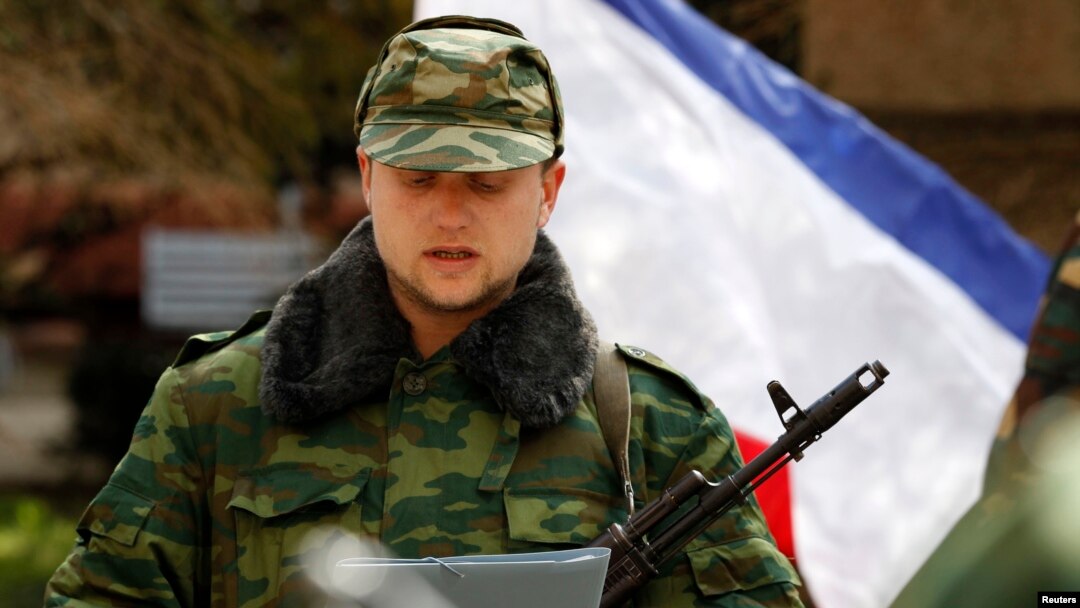 A member of a pro-Russian self defence unit swears an oath to the pro-Russia Crimea regional government in Simferopo, March 13, 2014.