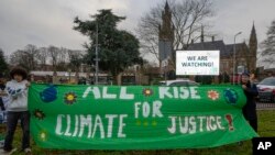 FILE - Activists protest outside the International Court of Justice in The Hague, Netherlands, at the beginning of hearings into what countries worldwide are legally required to do to combat climate change, Dec. 2, 2024.