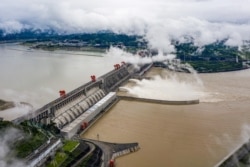 This aerial picture taken on June 29, 2020 shows wbeing ater released from the Three Gorges Dam, a gigantic hydropower project on the Yangtze river, in Yichang, central China's Hubei province.