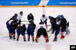 The joint Korean women's ice hockey players gather on the ice during a training session prior to the 2018 Winter Olympics in Gangneung, South Korea, Monday, Feb. 5, 2018.