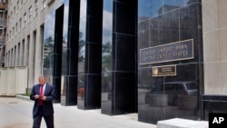 FILE - A man walks out of the Export-Import Bank of the U.S. in Washington.