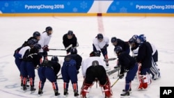 The joint Korean women's ice hockey players gather on the ice during a training session prior to the 2018 Winter Olympics in Gangneung, South Korea, Monday, Feb. 5, 2018. 