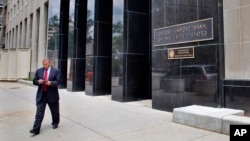 FILE - A man walks out of the Export-Import Bank of the U.S. in Washington.