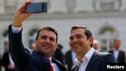 North Macedonia's Prime Minister Zoran Zaev, left, and Greek Prime Minister Alexis Tsipras attend a welcoming ceremony in Skopje, North Macedonia April 2, 2019. 
