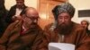 FILE- Maulana Sami ul-Haq (R), one of the Taliban negotiators, and Irfan Siddiqui, a government negotiator, discuss a joint statement before a news conference in Islamabad, Pakistan, Feb. 6, 2014.