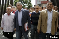 Pedro Carreno, second from left, deputy of Venezuela's United Socialist Party, arrives at the Supreme Court to challenge the swearing in of three opposition deputies, next to fellow deputies in Caracas, Jan. 7, 2016.