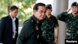 Thai Army chief General Prayuth Chan-Ocha arrives before a meeting to discuss the 2015 national budget at the Army Club in Bangkok, June 13, 2014. 