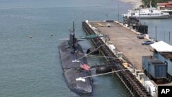 Crewmen work on the U.S. submarine USS Olympia which is docked at Subic Freeport, a former U.S. naval base, west of Manila, Philippines on a routine port call Oct. 8, 2012. 