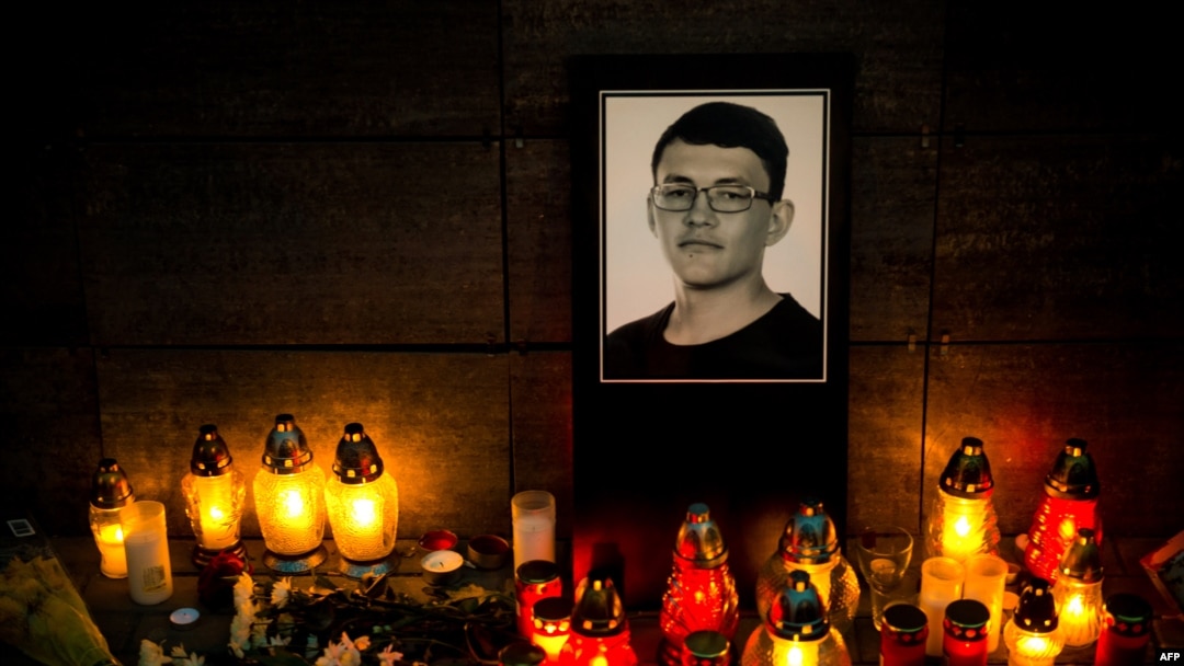 Candles and an image of investigative journalist Jan Kuciak are left outside Aktuality, the Slovakian news outlet where he worked. (Vladimir Simicek | AFP)