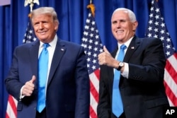 President Donald Trump and Vice President Mike Pence stand on stage during the first day of the 2020 Republican National Convention in Charlotte, N.C., Monday, Aug. 24, 2020. (AP Photo/Andrew Harnik)