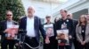 Jonathan Dekel-Chen, second from left, father of American hostage Sagui Dekel-Chen, along with other families of hostages in Gaza, speaks to reporters outside the White house in Washington, April 9, 2024. 