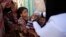 FILE - A boy receives a polio vaccination during a house-to-house polio immunization campaign in Sanaa, Yemen.