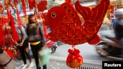 Fish-shaped decoration items are displayed for sale for 'Tet" in Hanoi, Jan. 21, 2014.