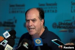 FILE - Julio Borges, president of the National Assembly and lawmaker of the Venezuelan coalition of opposition parties (MUD) talks to the media during a news conference in Caracas, Venezuela, Sept. 16, 2017.