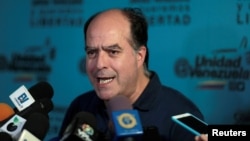 FILE - Julio Borges, president of the National Assembly and lawmaker of the Venezuelan coalition of opposition parties (MUD) talks to the media during a news conference in Caracas, Venezuela, Sept. 16, 2017. 