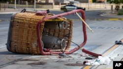 The basket of a hot air balloon that crashed lies on the pavement in Albuquerque, NM, June 26, 2021. 