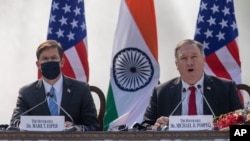 U.S. Secretary of State Mike Pompeo and Secretary of Defense Mark Esper seated beside him during a joint press conference in New Delhi, India, Oct. 27, 2020.