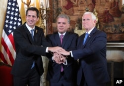 Venezuela's self-proclaimed interim president Juan Guaido, Colombia's President Ivan Duque and Vice President Mike Pence, pose for a photo after a meeting of the Lima Group concerning Venezuela at the Foreign Ministry in Bogota, Colombia, Feb. 25, 2019.