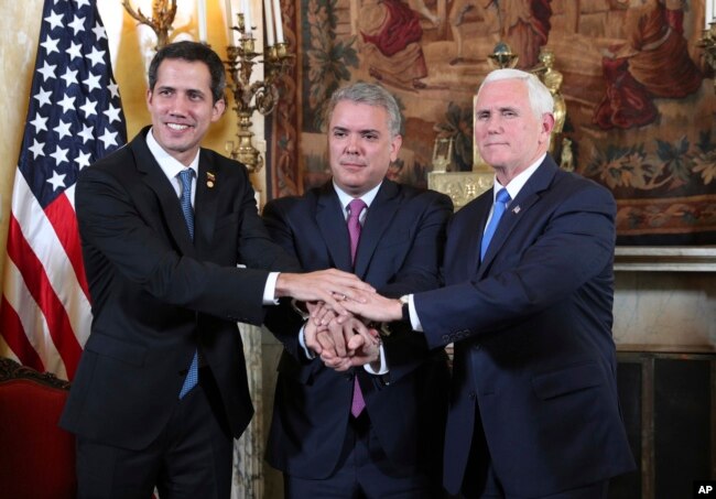 FILE - Venezuela's self-proclaimed interim president Juan Guaido, Colombia's President Ivan Duque and Vice President Mike Pence, pose for a photo after a meeting of the Lima Group concerning Venezuela at the Foreign Ministry in Bogota, Colombia, Feb. 25, 2019.