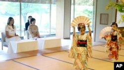 First lady Melania Trump, left, and Akie Abe, wife of Japanese Prime Minister Shinzo Abe, watch the performance of classical Japanese dancing at Akasaka Palace in Tokyo, Monday, May 27, 2019. (AP Photo/Koji Sasahara)