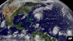 This image made available by the NOAA-NASA GOES Project shows Tropical Storm Norma, far left, on the Pacific Ocean side of Mexico; Hurricane Jose, center, east of Florida; Tropical Depression 15, second from right, north of South America; and Tropical Storm Lee, right, north of eastern Brazil, as of midafternoon Sept. 16, 2017. 