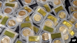 FILE: Some of 1,427 Gold-Rush era U.S. gold coins are displayed at Professional Coin Grading Service in Santa Ana, Calif., Tuesday, Feb. 25, 2014.