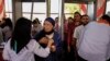 Teams help check people coming to attend the event of Virgin Mary at the Dronka mountain foot in Assiut, Egypt, August 20, 2017. (H. Elrasam/VOA)