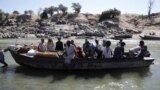 FILE - Ethiopians fleeing from the Tigray region arrive by boat to Sudan after crossing a river between the two countries, near the Hamdayet refugee transit camp, Sudan, Dec. 1, 2020. 