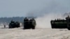 FILE - Amphibious Assault Vehicles, carrying American and Philippine troops, are seen on a beach during "Balikatan 2019" exercices, April 11, 2019, off San Antonio, Zambales province, northwest of Manila, Philippines. 