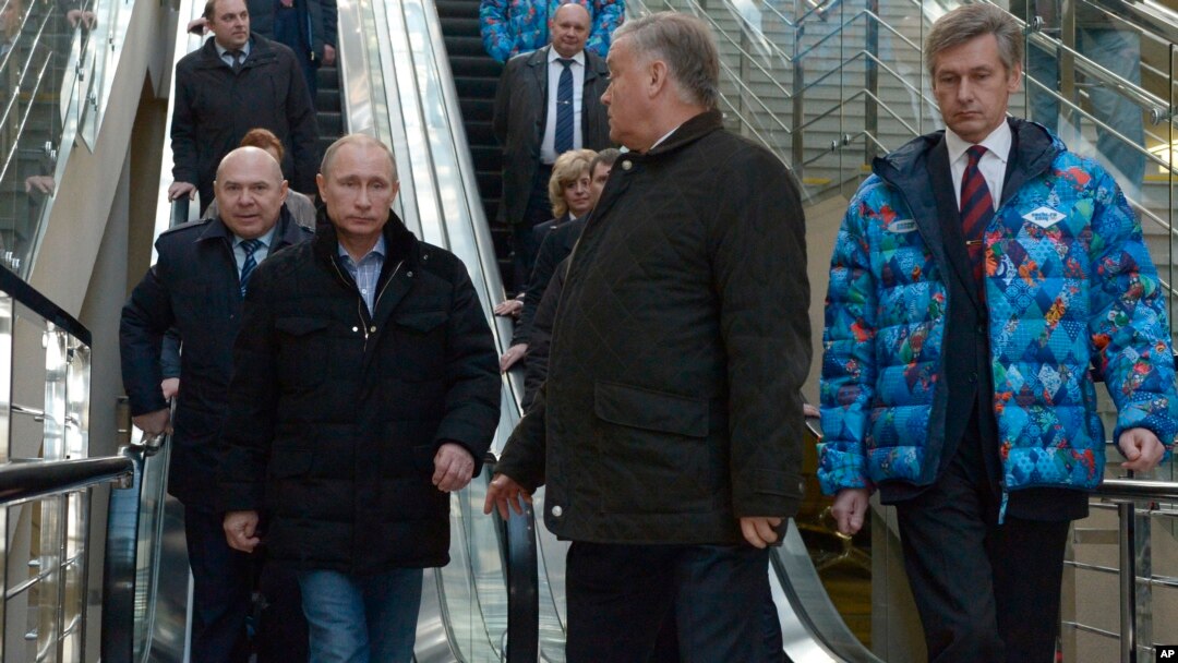 Russian President Vladimir Putin, foreground left, and Railways Chief Vladimir Yakunin, second right, visit the Olympic Park railway station at the Black Sea resort of Sochi, southern Russia, Jan. 4, 2014.