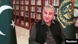 FILE - Pakistan's Foreign Minister Shah Mehmood Qureshi gestures as he speaks during an interview at the Foreign Ministry in Islamabad, Pakistan, March 1, 2020.