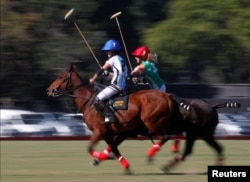 Argentina's Azucena Uranga and Ireland's April Kent compete for the ball at the Women's Polo World Championship.