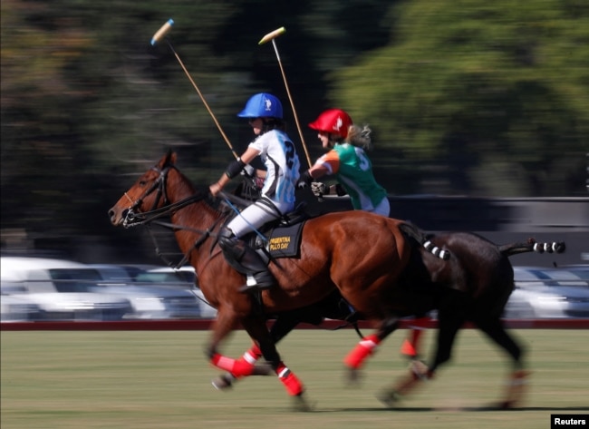Argentina's Azucena Uranga and Ireland's April Kent compete for the ball at the Women's Polo World Championship.