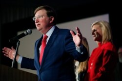 Mississippi Governor-elect Tate Reeves addresses his supporters, as his wife, Elee Reeves, right, listens, at a state GOP election night party on Nov. 5, 2019, in Jackson, Miss.