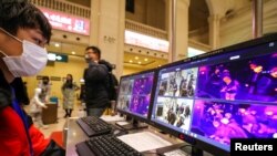 FILE - A staff member monitors thermal scanners that detect temperatures of passengers at the Hankou Railway Station in Wuhan, China, Jan. 21, 2020. To help guard against coronavirus, Senegal installed thermal cameras at the shipping port and airport.