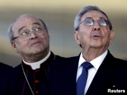 FILE - Cuba's President Raul Casto (R) and Cuba's Cardinal Jaime Ortega, leader of Cuba's Catholic Church look at Pope Francis' plane at Jose Marti airport in Havana, Feb. 12, 2016.